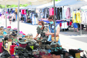 Dos clientes en una parada de sabates al mercadillo del Camp d’Esports.