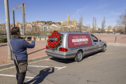 Un ciutadà fotografia el cotxe fúnebre de la campanya de Trànsit ahir al seu pas per Lleida ciutat.