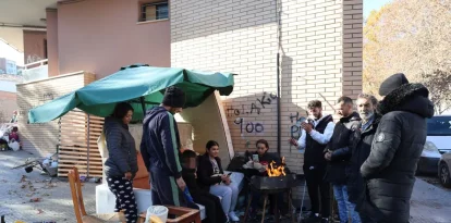 David Escudero, la seua dona, Rosario Jiménez, el seu fill i altres desallotjats, vora el bloc de pisos. - AMADO FORROLLA