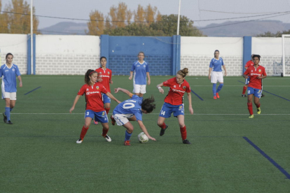 Una jugadora del AEM trata de controlar el balón ante la oposición de dos rivales.