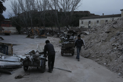 Personas buscando materiales que poder vender entre los escombros del derribo de la antigua escuela de Magisteri.