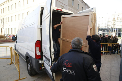 Dos operaris van carregar a la furgoneta la caixa amb la pintura de la Immaculada, ahir al Museu de Lleida abans de sortir cap a Sixena.