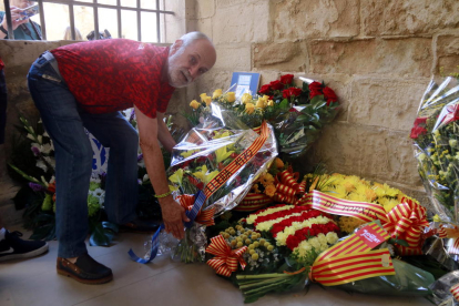 Un membre de la Penya Barcelonista de Lleida diposita l'ofrena floral de la Diada al Roser.