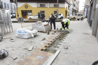 Un grup d’operaris repavimentaven el carrer del Riu, ahir.