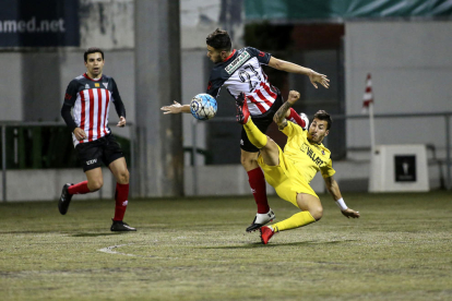 El jugador del Balaguer Genís remata de forma acrobàtica davant de la presència d’un jugador del Viladecans.