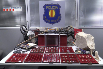 Imagen de las monedas, el detector y otros utensilios encontrados en el domicilio del acusado.