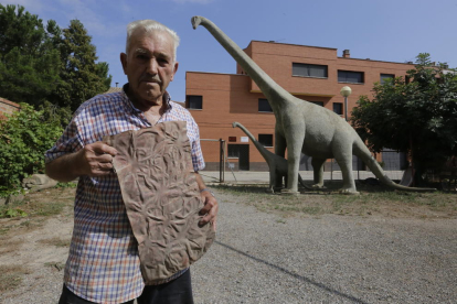 Antoni Gené, con la pieza que usó para simular la piel rugosa de los dinosaurios en el cemento. 