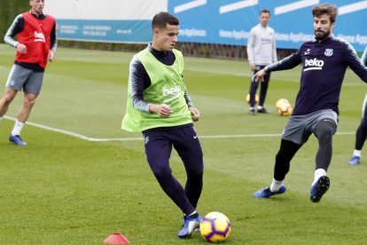 Philippe Coutinho, al costat de Gerard Piqué, durant l’entrenament d’ahir a la Ciutat Esportiva.