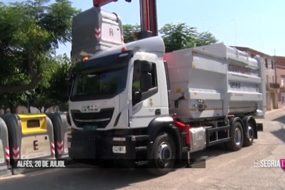 El camión de recogida de los nuevos contenedores en Alfés.