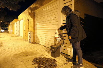 Una vecina de Ciutat Jardí, sacando una bolsa de basura el pasado viernes.