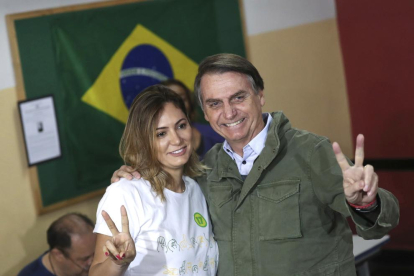 El candidato ultraderechista, Jair Bolsonaro, y su esposa, Michelle, ayer, después de votar.