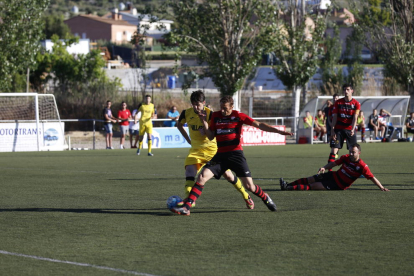 Un jugador del EFAC Almacelles y uno del Balaguer intentan controlar un balón dividido.