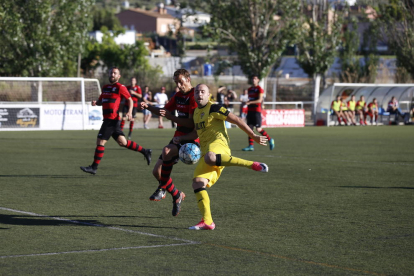 Un jugador del EFAC Almacelles y uno del Balaguer intentan controlar un balón dividido.