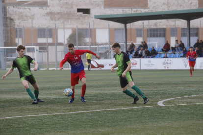 Un jugador del Torrefarrera conduce el balón ante la vigilancia de un defensor del Cervera.