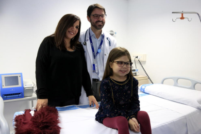 Iría, la niña de diez años con una enfermedad ultra-rara que ha sido trasplantada de corazón, hígado y riñón en el Vall d'Hebron, con su madre, Judith, y el doctor Jesús Quintero, a la consulta.
