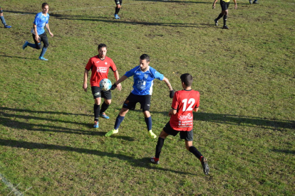Un jugador del Sant Guim trata de controlar el esférico ante la presión de varios rivales.