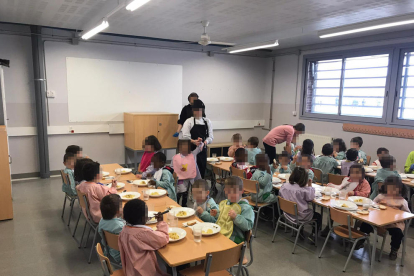 Imatge dels nens i nenes de P3 de l’escola Parc del Saladar d’Alcarràs mentre dinen en una aula.