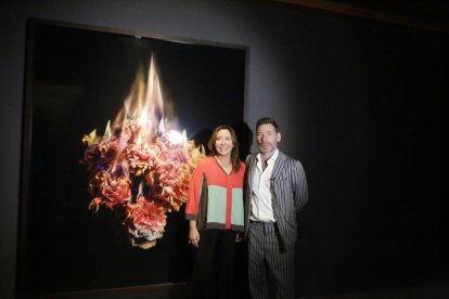 La directora de la Fundació Sorigué, Ana Vallés, i Mat Collishaw, al costat d’una obra de flors ‘en flames’.
