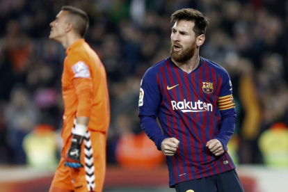 Leo Messi celebra el gol que va anotar de penal i que va servir per sentenciar el partit, amb l’exporter blaugrana al fons lamentant-se malgrat ser el millor del seu equip.