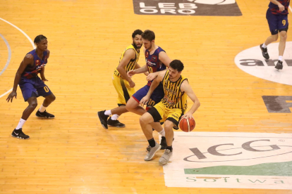 Carlos Gasque porta la pilota davant de Jaime Fernández.