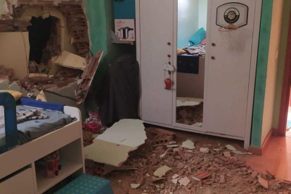 La roca de un talud atraviesa la pared de una casa en Gerri de la Sal