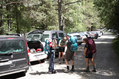 Turistas ayer en Sant Climent de Taüll, el camping de la Vall d’Àger y un grupo de senderistas en el parking del Parc Nacional d’Aigüestortes i Estany de Sant Maurici en Espot. 