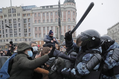 Manifestantes encaramados a una farola en Moscú, ayer.