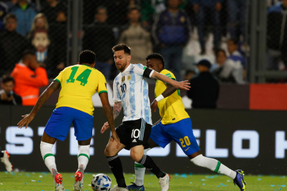 Leo Messi intenta superar a los brasileños Militao y Vinicius.