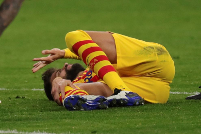 Gerard Piqué, en el suelo tras chocar con Correa, supo en un primer momento que la lesión en su rodilla derecha era importante.