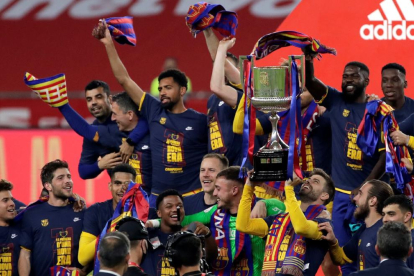Messi y Joan Laporta se funden en un abrazo cuando el capitán barcelonista se dispone a recoger la Copa que se ve al fondo.