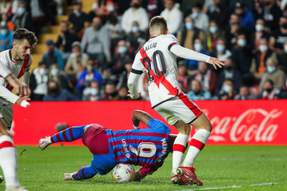 Memphis Depay, que falló un penalti, cae ante el defensa del Rayo Vallecano Balliu.