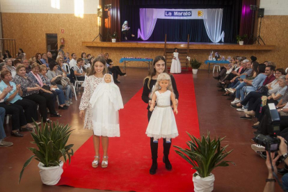 Niñas y adolescentes de Preixana sacaron a desfilar los trajes de bautizo con muñecos.