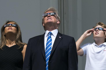 Imagen del eclipse (izq.). Melania y Donald Trump lo siguieron desde la Casa Blanca (centro). El leridano Joan Teixido, en Nueva Orleans (d).