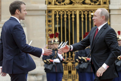 El presidente francés, Emmanuel Macron, saluda a su homólogo ruso, Vladimir Putin.