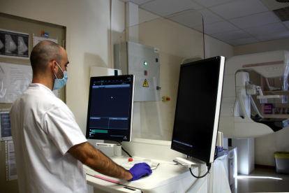 Un técnico del Instituto Catalán de Oncología utilizando el mamógrafo para hacer las pruebas para el cribado del cáncer de mama.