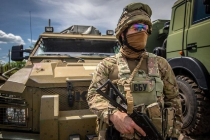 Un soldado ucraniano frente a un vehículo blindado.