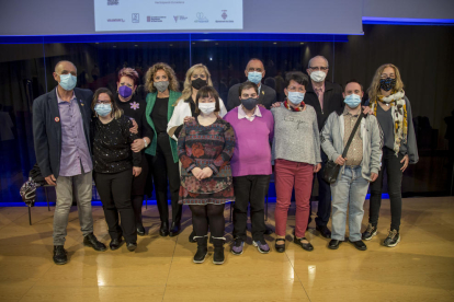 Autoritats amb joves de Down Lleida, que van oferir un recital poètic. A la dreta, Berta Puigdemasa tocant l’arpa amb el seu fill.