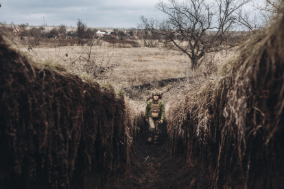 Un soldat de l'exèrcit ucraïnès camina per una trinxera al front de Niu York, a 22 de febrer de 2022, Niu York, Oblast de Donetsk (Ucraïna).
