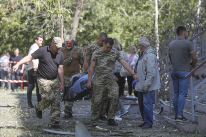 Els equips de rescat traslladen el cos d’una víctima a Kíiv.
