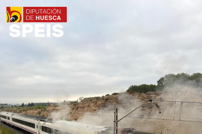 Un bombero apagando las llamas en el convoy. 