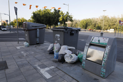 Caixes al costat d’un contenidor de paper i cartró a la plaça Santa Maria Magdalena (Clot).