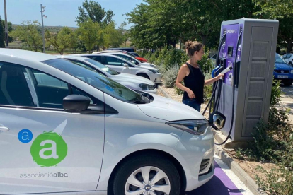 Una trabajadora de Alba cargando uno de los nuevos coches.