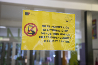 Un cartell que publicita la prohibició de mòbils en un centre educatiu de Tàrrega.