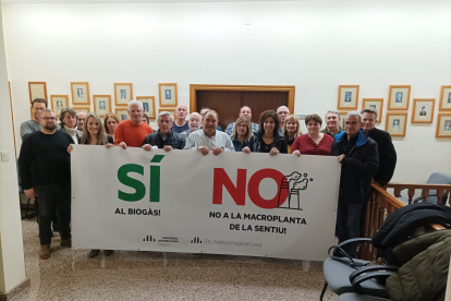 Edils i militants d’ERC, ahir rere una pancarta contra la planta.
