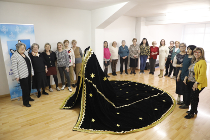 Alumnes del taller de confecció de l’Associació de Veïns de la Zona Alta van posar ahir al costat del mantó que han creat per a la Verge de la Soledat de Lleida.