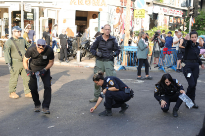 La policia inspecciona els danys al lloc de l’explosió.