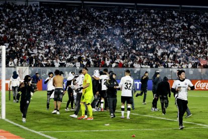 Aficionats del Colo Colo xilè envaeixen el terreny de joc. - EFE