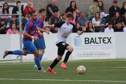 Un jugador del Vallfogona condueix la pilota davant de la pressió d’un rival. - JOAN BOVÉ