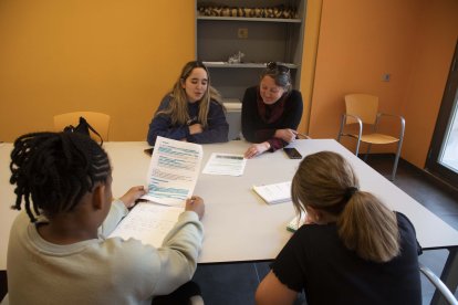 La monitora i la tècnica del Pla Educatiu d’Entorn, amb dos estudiants al Refugi Estudiantil. - CARMINA MARSIÑACH
