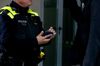 Un agent de la Policia Local de Cunit identifica una persona per creuar les vies